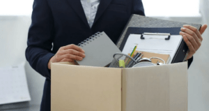 man holding box of office supplies
